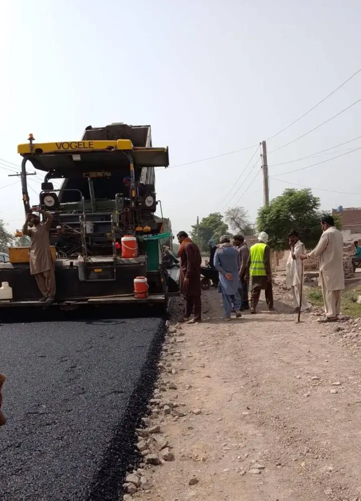 Asphalt being laid under bridge